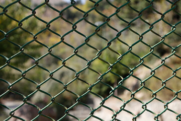 Fototapeta premium Metal mesh in the environment. The background is blurred