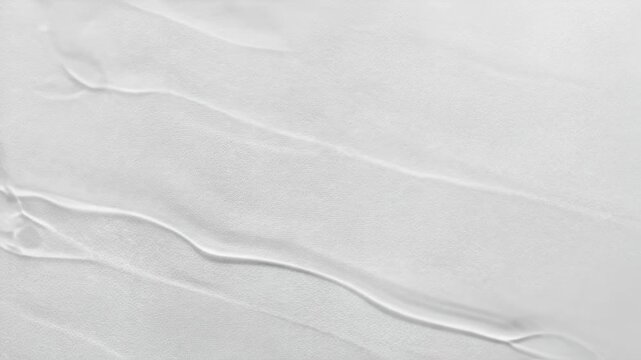 Transparent gel with bubbles flows down the surface close up. Cosmetic product serum for moisturizing and nourishing the skin. Macro texture of beauty spa product