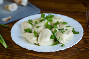 Homemade dumplings with potato filling and fresh herbs
