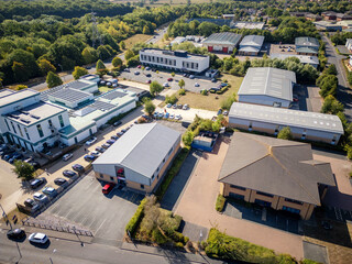 Modern industrial estate with warehouses, logistics distribution hub, business park offices and commercial property, featuring warehouse buildings, trading estate units and logistics facilities