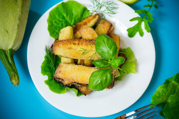 Vegetable appetizer of zucchini and dill on a blue background