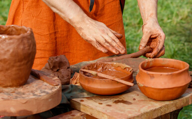 Man is making pottery on a table