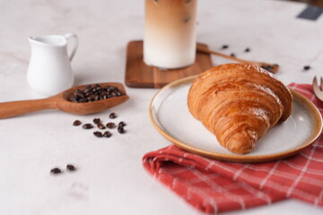Coffee shop breakfast set with croissants and iced cappuccino, a refreshing drink.