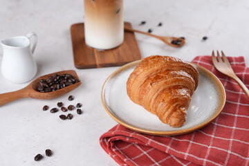 Coffee shop breakfast set with croissants and iced cappuccino, a refreshing drink.