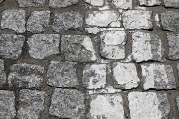 Obraz premium A detail of the cobblestone road in Mielno, Poland