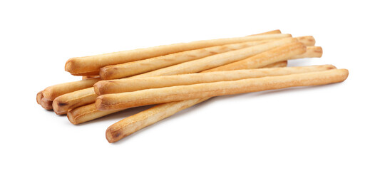 Many delicious grissini sticks isolated on white