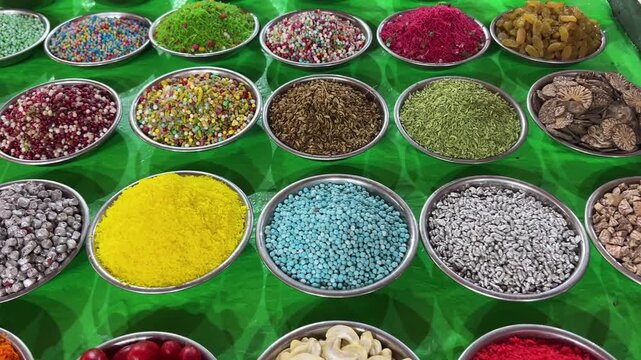 Different types of ingredients of paan like cherry, betel leaves, sold in a market in India