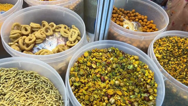 Different types of Gujarati snacks like chanachur, khakra sold in a market in India
