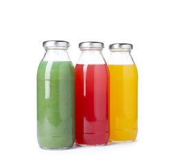 Tasty juices in glass bottles isolated on white