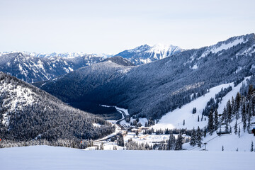Snowy Alpine Ski Resort: Tranquil Mountain Scene with Snow-Capped Peaks, Ski Lift, and Sunset
