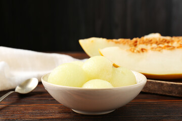 Cut ripe melon on wooden table, closeup