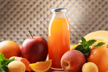 Tasty juice in glass bottle, fresh fruits and mint on wooden table indoors, closeup