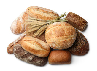 Different types of bread and wheat spikes isolated on white, top view