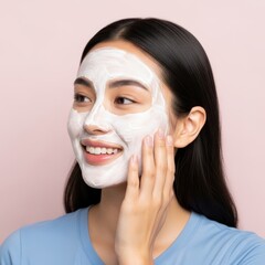 Woman smiling while applying a white face mask