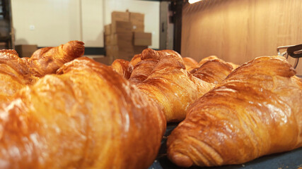 Delicious croissants photo image close up display in bakery showcase golden baked pastries perfect...