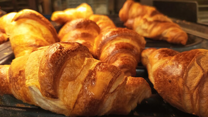 Delicious croissants photo image close up display in bakery showcase golden baked pastries perfect...