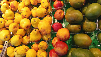 Close up photo of various type fresh fruits arrange neatly grocery store quince avocado peach on rack background horizontal hd resolution image poster banner background perfect for campaigns 