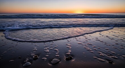 Obraz premium Sunrise washes tranquil beach. Waves kiss shore, scattered shells
