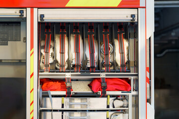 Emergency equipment storage in a fire truck showing organized gear and tools for firefighting...