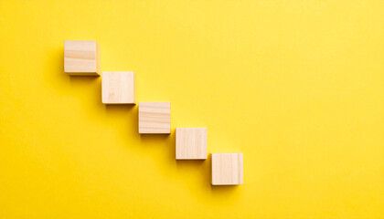 Wooden cubes forming an ascending staircase. Business growth, success and achievement concept.