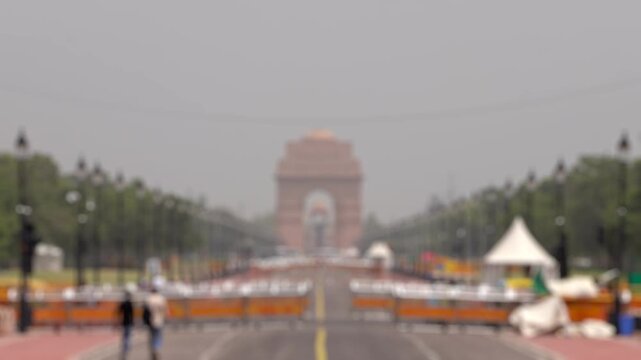 Bokeh view of Kartavya Path in front of India Gate during the heatwave season in New Delhi, India. Blurred background footage.