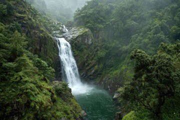 Waterfall cascading into a pool in a lush valley