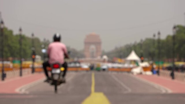 Bokeh view of Kartavya Path in front of India Gate during the heatwave season in New Delhi, India. Blurred background footage.