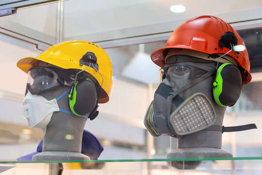 Mannequins in helmet, safety glasses, headphones and a respirator on the showroom