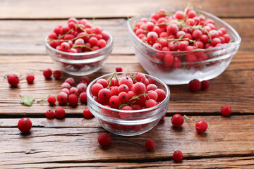 Ripe frozen red currants on wooden table, closeup