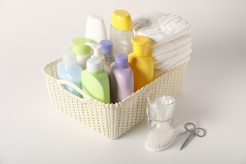 Baby accessories and body care products on light background