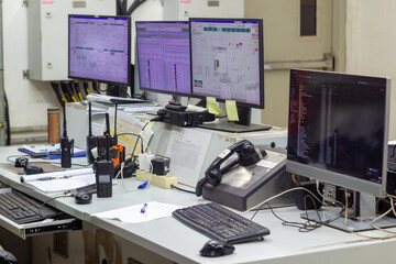 Control Room Operations Desk with Multiple Monitors and Radios