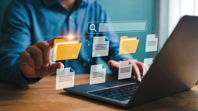 Business professional accessing digital files and documents on laptop using search bar