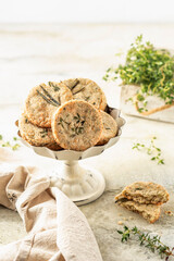 Shortbread cheese cookies with aromatic herbs on rustic textured background. Savory parmesan cookies for party