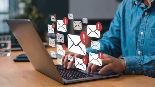 Man working on laptop with email notifications, symbolizing urgent messages and online communication