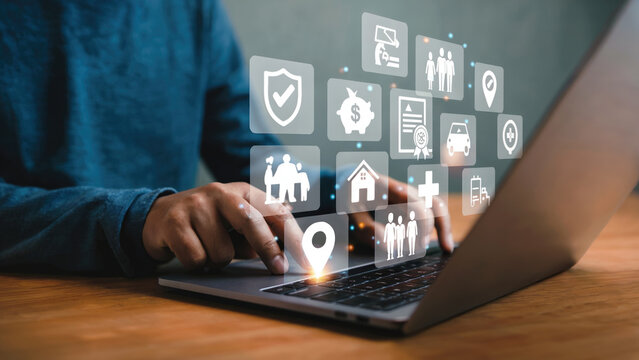 Person using laptop with insurance and financial icons representing security and protection