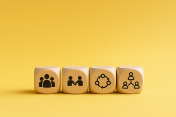 Teamwork Concepts on Wooden Blocks Illustrating Collaboration, Networking, Partnership, and Connection on a Yellow Background
