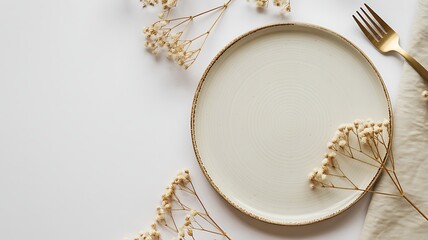 Elegant table setting with minimalist plate golden fork and delicate gypsophila flowers on a clean white background perfect for food photography and dining concepts