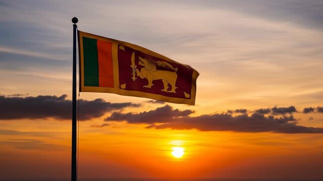Sri Lanka Flag Waving at Sunset - The Sri Lankan flag waves proudly on a flagpole against a vibrant sunset. Warm orange and yellow hues fill the sky, creating a dramatic and patriotic backdrop.
