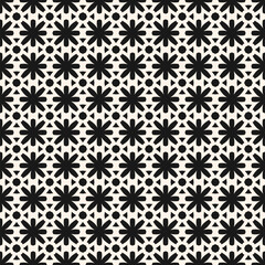 Simple vector seamless pattern in ethnic folk style. Cute black and white floral geometric ornament. Vintage background texture with small flower silhouettes, grid. Repeating decorative design