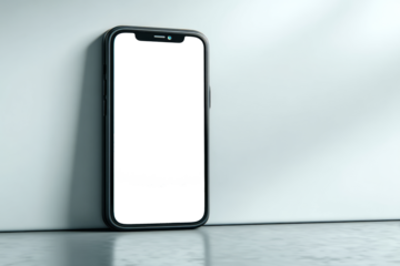 A black and white cell phone is sitting on a white wall. PNG transparency.