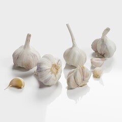 Fresh garlic bulbs and cloves on a white background.