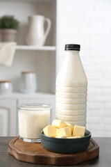 Different dairy products on gray textured table in kitchen