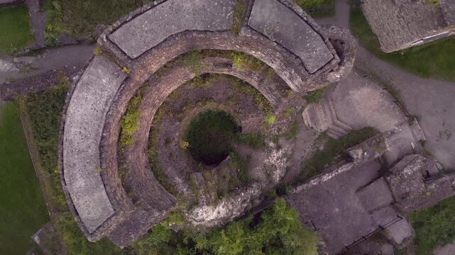 Vertical drone flight rising from inside the tower of Windeck Castle ruins in North Rhine-Westphalia, Germany, with top-down view and 180-degree rotation revealing medieval fortress structure