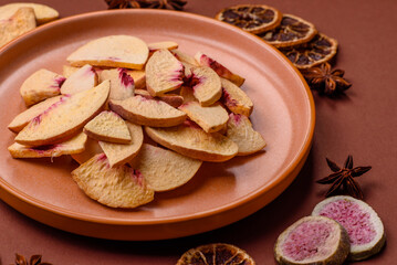 Dried sublimated slices of peach or apricot as an ingredient for sweet desserts. Dried peach