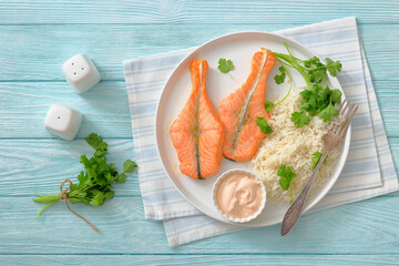 baked salmon steaks with rice, cilantro and sauce