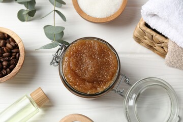 Natural body scrub, ingredients and towels on white wooden table, flat lay
