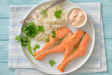 baked salmon steaks with rice, cilantro and sauce