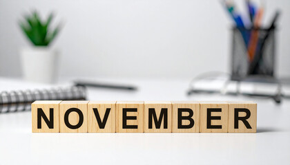 Wooden cubes with word NOVEMBER on desk. Planning, monthly goals or time management