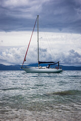 Fototapeta premium Sailboat off the coast with dramatic clouds in the background. Adriatic Sea, Croatia