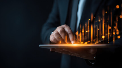 Innovative technology concept showcasing businessman interacting with digital tablet, featuring glowing data visualizations and graphs. image conveys sense of progress and modernity
